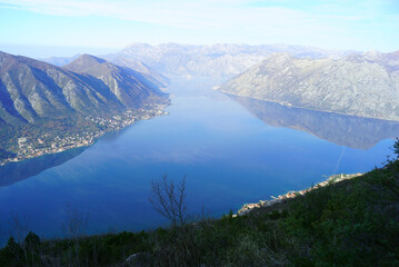 Fototapeta premium Mountain hiking reward overlooking Kotor bay, Montenegro. Breathtaking panoramic vista from Dinaric Alps trail. Adventure travel, outdoor recreation, summit photography, wilderness exploration concept