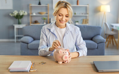 Happy woman putting coin in piggybank to enjoy saving money, managing household budget at home,...
