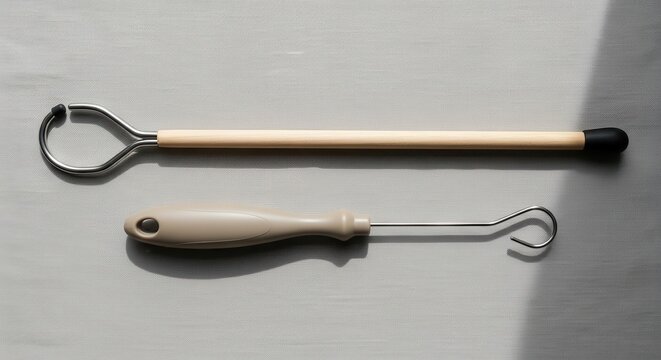 Dressing sticks and button hooks arranged on a neutral backdrop, flat-lay style, for easy dressing