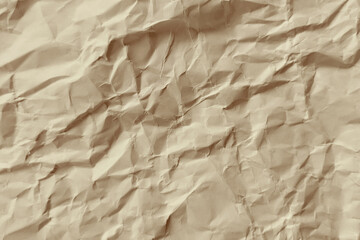 Piece of tan crumpled paper with rough texture detail. Suitable for backgrounds, design elements, texture overlays, and vintage aesthetics.