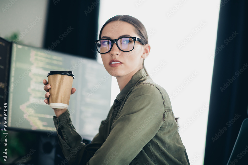 Aufkleber young female programmer working from home office with a coffee cup, coding and developing software o