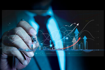 Businessman using pen touch holographic graphs and stock market statistics gain profits. Stock...