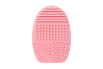 A pink silicone makeup brush cleaning mat with various textures for deep cleaning, isolated on a transparent background
