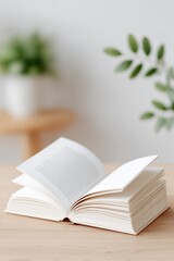 Open book on wooden table, surrounded by greenery, inviting crea