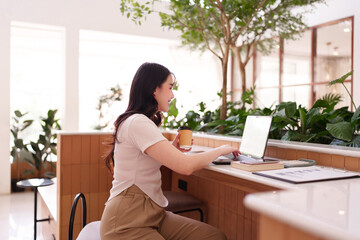 Asian adult woman productive remote work cafe digital nomad lifestyle online business computer...