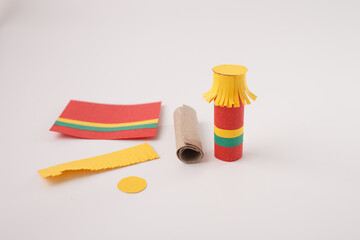 Colorful handmade paper craft with cardboard tube and festive decorations, ideal for DIY blogs,...