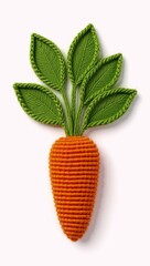 Isolated artificial carrot with knitted green leaves on white background