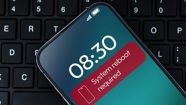 4K video of a smartphone screen displaying a System reboot required notification. This illustrates software errors, phone troubleshooting, tech support