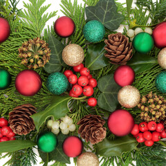 Christmas traditional background with bauble decorations, holly, mistletoe berries, ivy, fir, pine cones. Xmas flora design for holiday season on white.