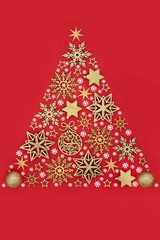 Christmas tree concept shape, gold stars, snowflakes, ball spheres, white snowflake decorations on red background. Icon symbol for the Xmas holiday season.