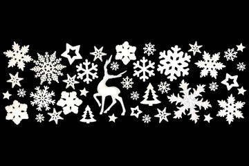 Christmas white reindeer, snowflakes, trees, stars,  decorations, festive banner on black background. Abstract design for Xmas holiday season.