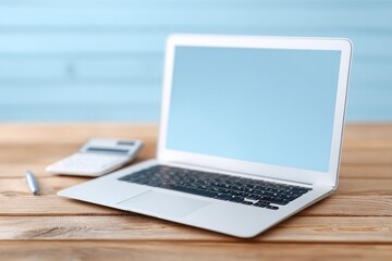 Fototapeta premium Sleek laptop on wooden table, minimalist design, soft blue backg