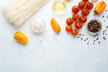various cooking ingredients noodles vegetables spices on white background