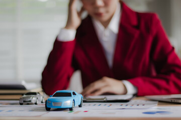 Asian businesswoman in suit smiling while advising clients on insurance policies, trusts, finances...