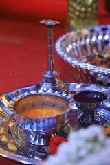 Traditional Indian puja thali with diya, kumkum, rice, and offerings for rituals.