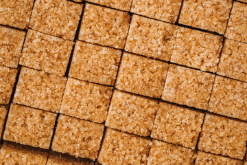 Assorted brown sugar cubes arranged neatly on a light surface