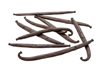Close-up of dried vanilla beans arranged against a black background for culinary use