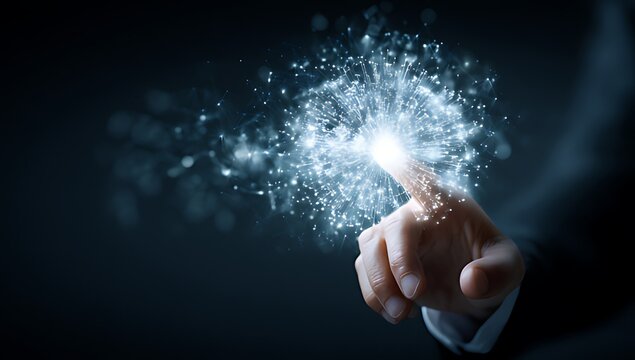 Hand touching glowing particles in dark space with finger