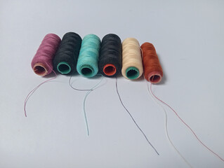 spools of thread with multi color isolated white background. 