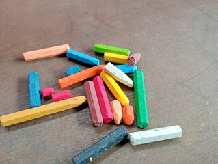 Broken crayons on table. Often used crayons broke. 