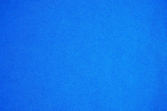 Vibrant texture of a high-quality blue fabric surface with closeup details