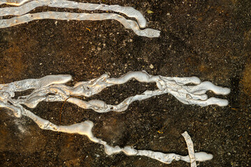 An abstract background of cooled silvery molten metal.