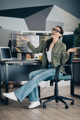 Young female developer enjoying a productive software coding session in a modern office workspace...