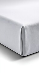 Close-up of a white fabric, likely a sheet or cover, with a folded edge