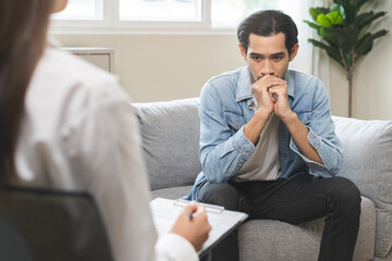 Psychology, depression. Suffer asian young man consultation with psychologist while patient...