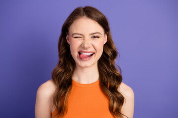 Adorable and charming with an expressive pose against a purple background, showcasing youthful...