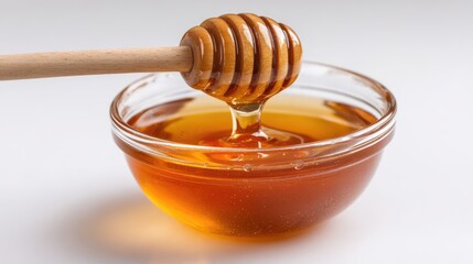 Honey pot and dipper on white background.