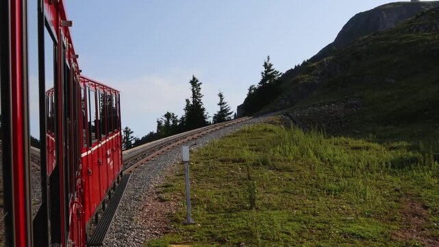 Schafberg, Austria - August 4, 2025: Schafbergbahn retro traditional cog railway riding on top of mountain Schafberg. Tourist attraction