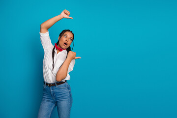 Young woman with braided hair displays charm while gesturing with enthusiasm in modern casual...