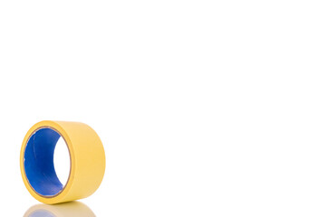 One roll of masking tape, close-up, isolated on white background.