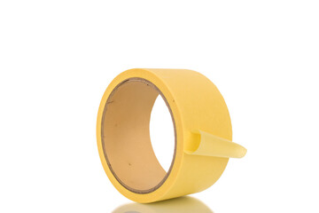 One roll of masking tape, close-up, isolated on white background.