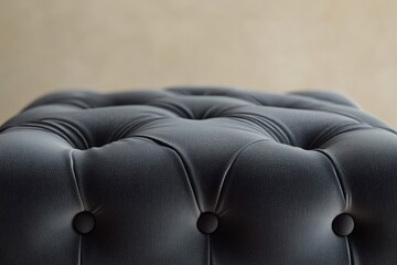 Close-up of a luxurious, gray-toned, tufted upholstery with elegant button detailing, creating a sophisticated and comfortable aesthetic.