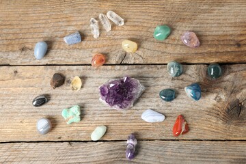 Aura. Different natural mineral stones on wooden table, flat lay