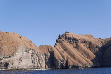 Fototapeta premium Scenery of mountain range with a blue sky in the background in Labuan Bajo, Indonesia.