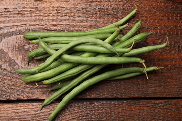 Fresh pea pods on wooden table, flat lay
