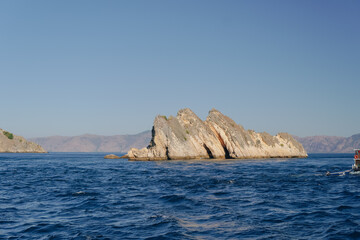 Scenery of mountain range with a blue sky in the background in Labuan Bajo, Indonesia.