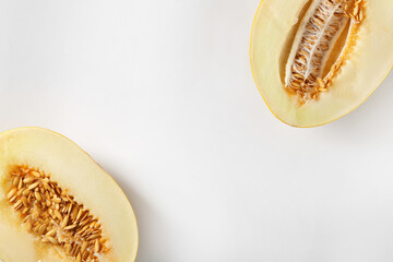 Halves of ripe melon on white background, flat lay. Space for text
