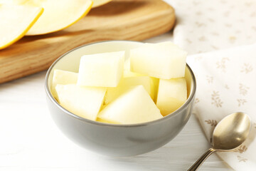 Cut ripe melon on white wooden table, closeup