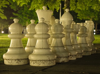 Outdoor White Chess Pieces at Night