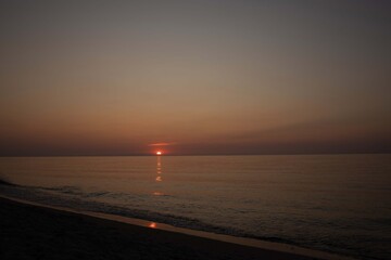 Fototapeta premium lighthouse on the beach the last minutes on the beach before sunset, a beautiful atmospheric picture