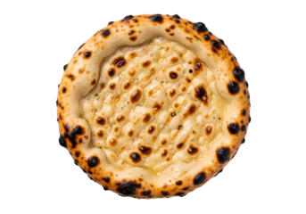 Close-up of a baked cheese naan bread with charred spots on a black background