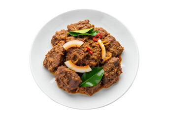 Crispy fried chicken pieces garnished with onions and peppers on a white plate against a black
