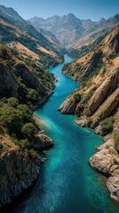 Naklejka premium Serene river winding through rugged mountains under a clear blue sky during the day