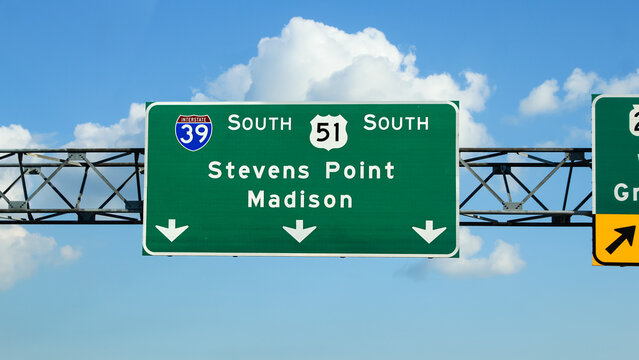 A highway sign for Stevens Point and Madison Wisconsin. The junction of US Highway 51, and Interstate 39. Transportation, travel, business opportunities or tourism banner. Midwest USA background.