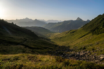 Fototapeta premium alpine landscape in early morning after sunrise with layers of mountains in the background in Damüls Bregenzer Wald in Vorarlberg Austria 