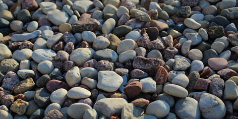 Rock banner. Macro closeup of river rock, a natural stone product commonly used in landscaping and...